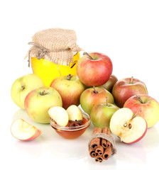 Honey and apples with cinnamon isolated on white