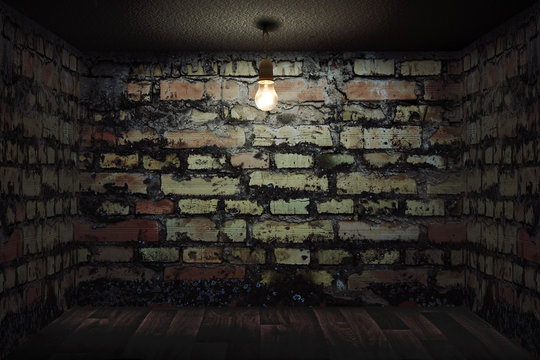 Habitación oscura con paredes de ladrillo