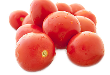 wet cherry tomatoes on a white background