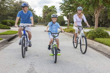 Young Family Parents and Boy Son Cycling