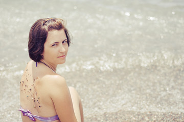 Caucasian woman on the beach near sea