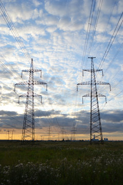 Electrical transmission towers at cloudy sunset