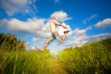 woman jumping over the blue sky