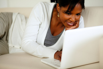 Young woman browsing the Internet on laptop