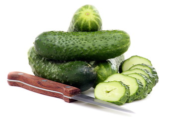 Fresh juicy cucumbers and knife for cutting vegetables.