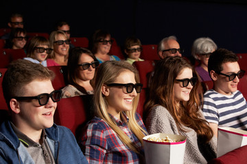 Fototapeta premium Group Of Teenage Friends Watching 3D Film In Cinema