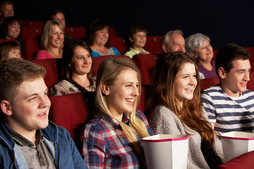 Group Of Teenage Friends Watching Film In Cinema