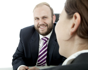 beard business man brunette woman at desk is happy