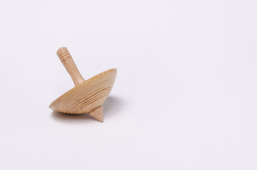 Little spinning top resting on white background