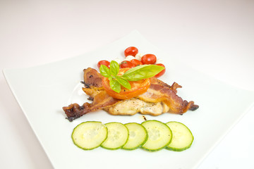 Delicious chicken with bacon on white
