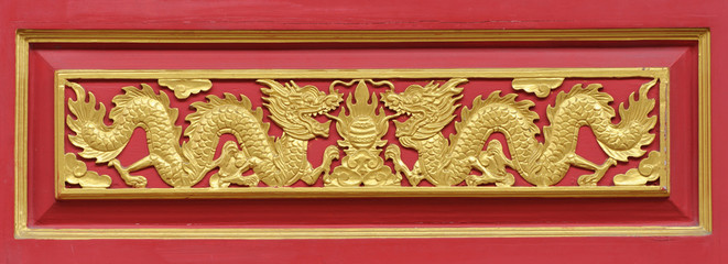 golden dragon decorated on red wood wall