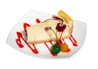 Closeup of a slice of cherry cheesecake on a white background