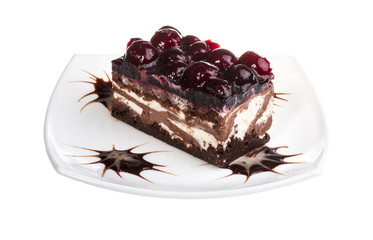 Chocolate cake with cherry on top on a white background