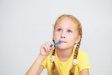 Little girl  raising finger in funny attention gesture isolated