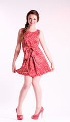 Beautiful young woman in fashion pink dress