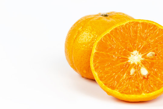 Sliced orange fruit segments on white background