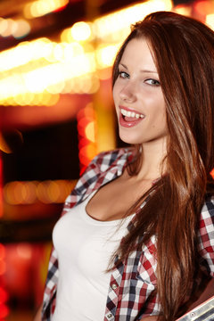 Attractive brunette woman against night city