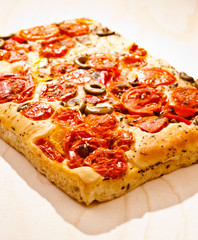 focaccia with tomatoes, olives, artichokes and vegetables