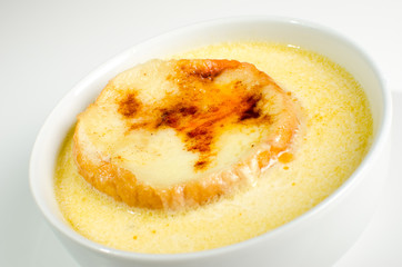 Onion soup on white bowl