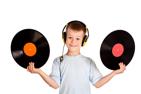 little boy with headphones and records