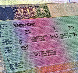 Obraz premium Schengen visa in passport for ukrainian citizen, business travel document, legal work emmigration, Europe tourism diversity 