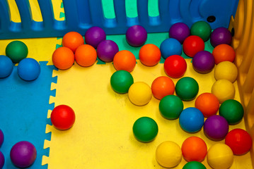 plastic balls of different colors on the playground