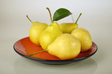 pears on orange plate