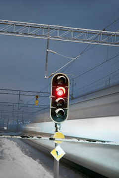 Train and red signal at railway crossing