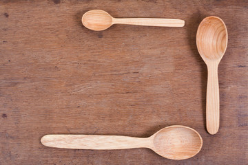 Wooden kitchen spoons on oak wood table background