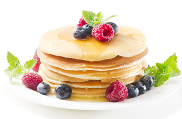 pancakes with raspberries and blueberries isolated on white