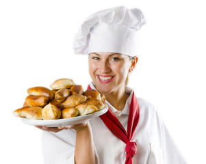 Young woman chef holding a plate with pies
