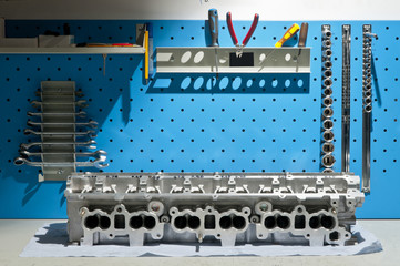 The block of cylinders from the engine of a sports car on a work