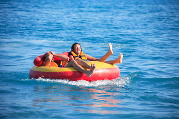 Friends Tubing On Sea