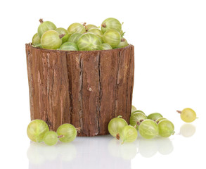 Green gooseberry in wooden cup isolated on white