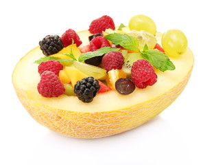fresh fruits salad in melon, isolated on white