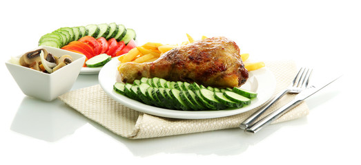 Roast chicken with french fries and sliced vegetables