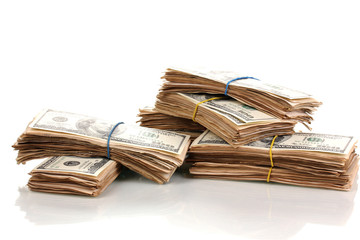 Stacks of one hundred dollars banknotes close-up isolated