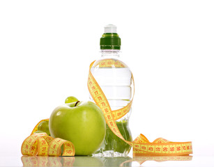 green apple, bottle with aqua and small grapes