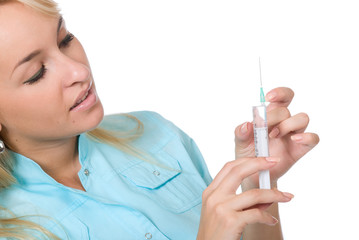 A young pretty female doctor holding a hypodermic needle