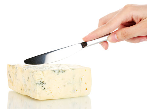 Woman's hand cut blue cheese on white background close-up
