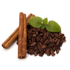Crushed chocolate shavings pile and cinnamon sticks