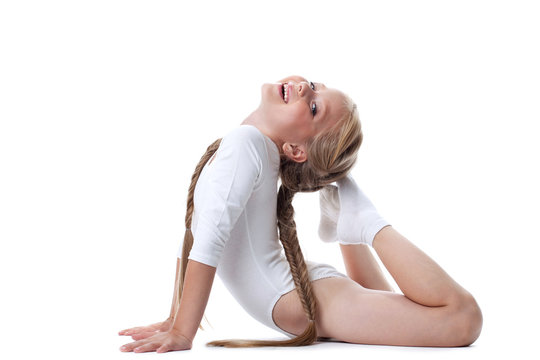 Pretty girl performing gymnastic exercises
