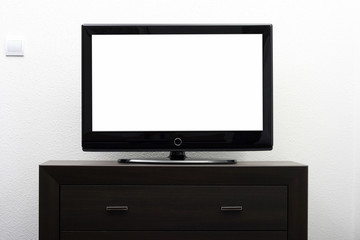 blank tv screen on brown commode against white wall