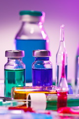 Medical laboratory glass equipment still life on blue purple