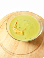 spinach cream soup with shrimp on the desk over white