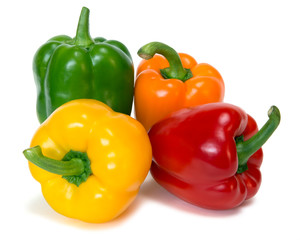 colored peppers over white background