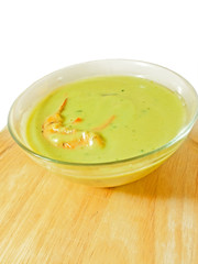 spinach cream soup with shrimp on the desk over white