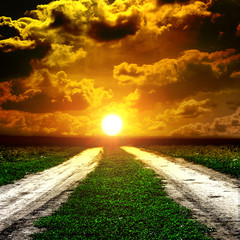 Road in field with clouds