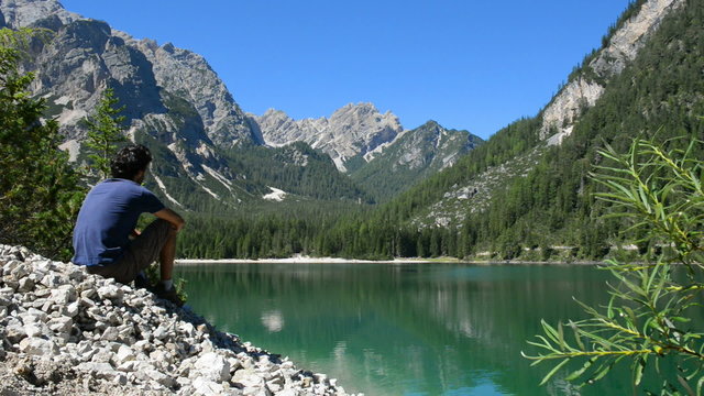Young man contemplate the panorama over the Pragser Wildsee