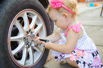 Lillte child playing in auto mechanic